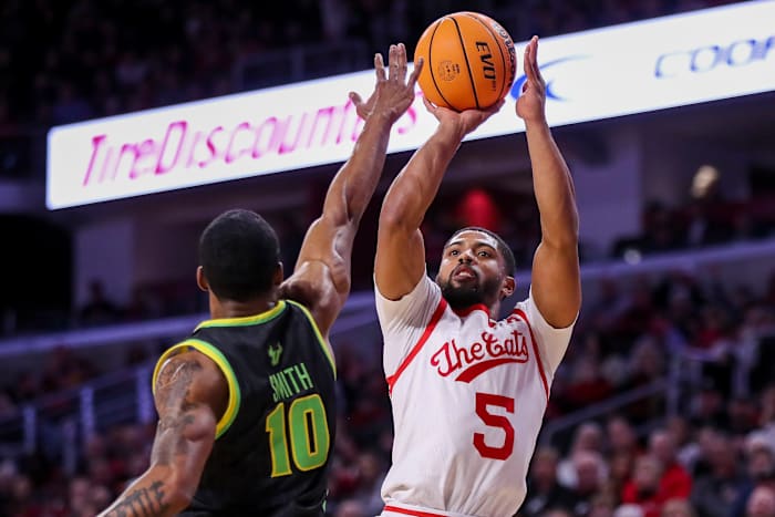 Feb 11, 2023; Cincinnati, Ohio, USA; Cincinnati Bearcats guard David DeJulius (5) shoots against South Florida Bulls guard Serrel Smith Jr. (10) in the first half at Fifth Third Arena. Mandatory Credit: Katie Stratman-USA TODAY Sports